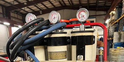 Portable fuel polishing system with dual filter canisters and pressure gauges in operational facility setting GmDNH70Fp77IxAaJ_BZi6BN-xo2iQdqt51iJEra6kkQ=.jpg