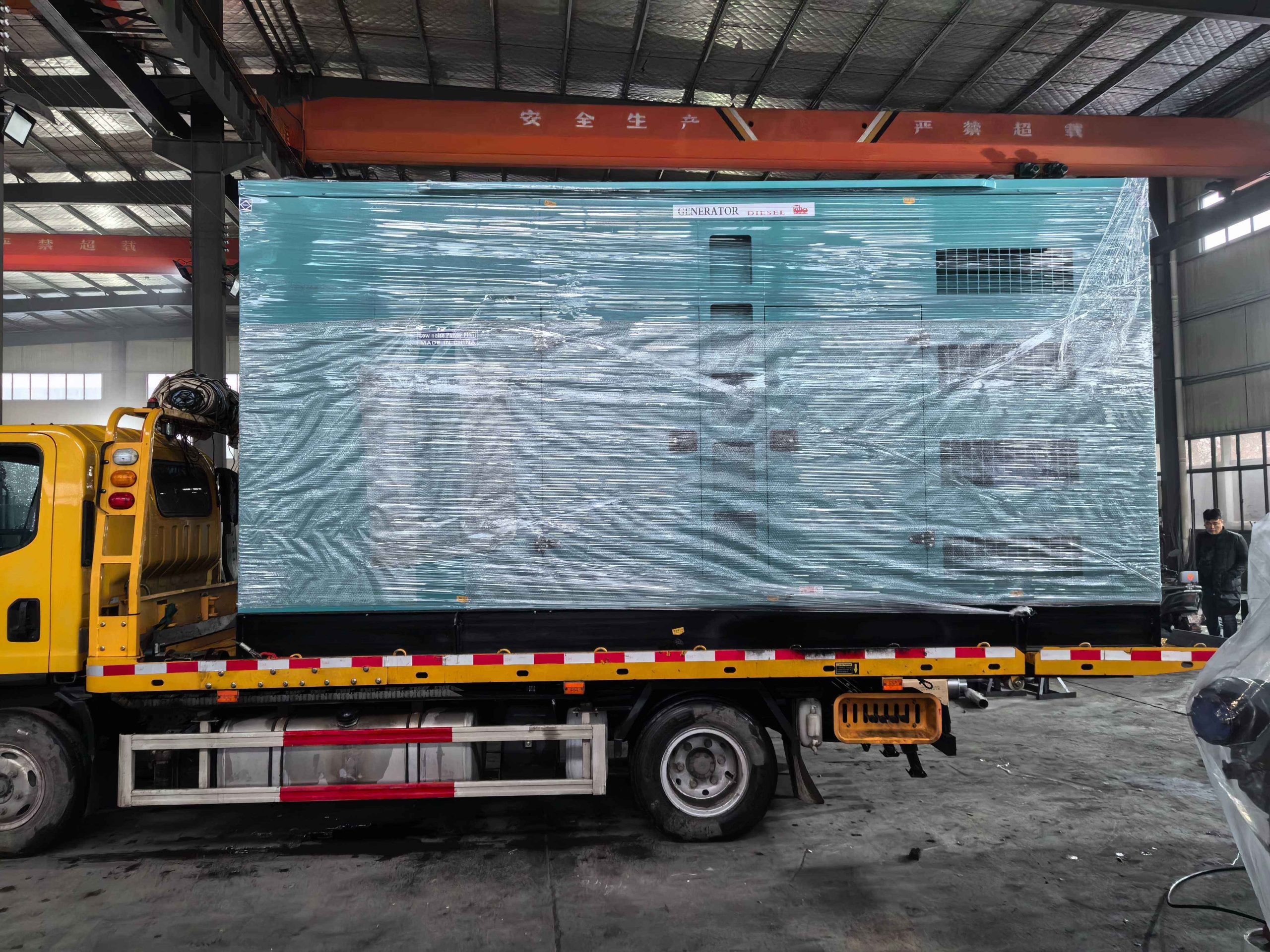 Containerised and trailer-mounted diesel generator sets standing in a yard before dispatch to site