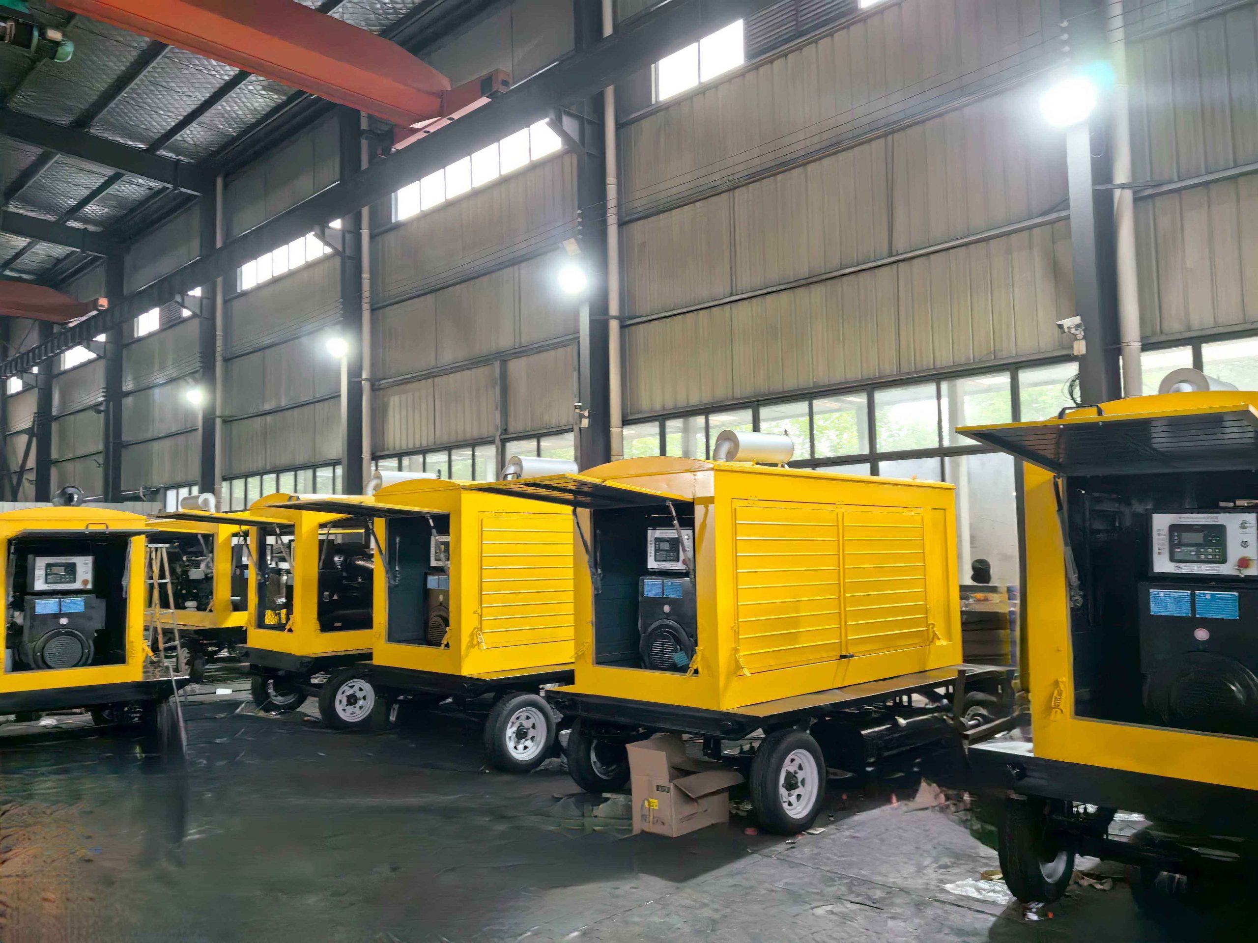 Trailer-mounted diesel generator set with drawbar, axle and canopy on a paved yard