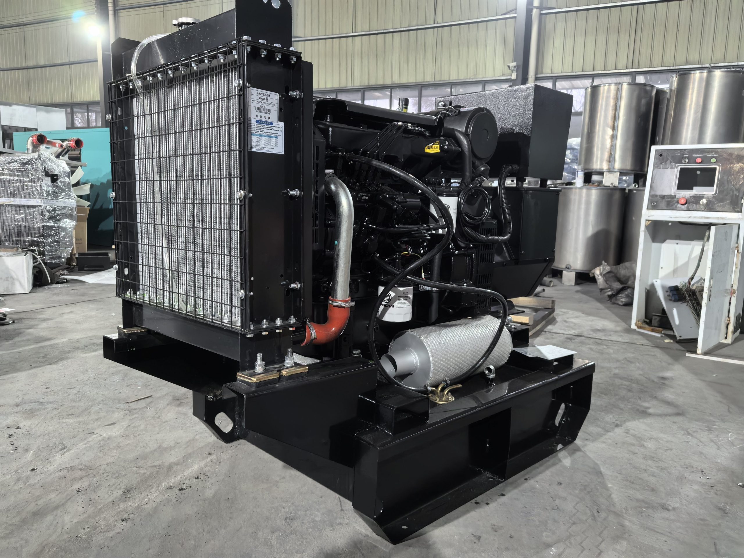 Open-frame diesel generator set on a factory skid with radiator, engine and control panel visible