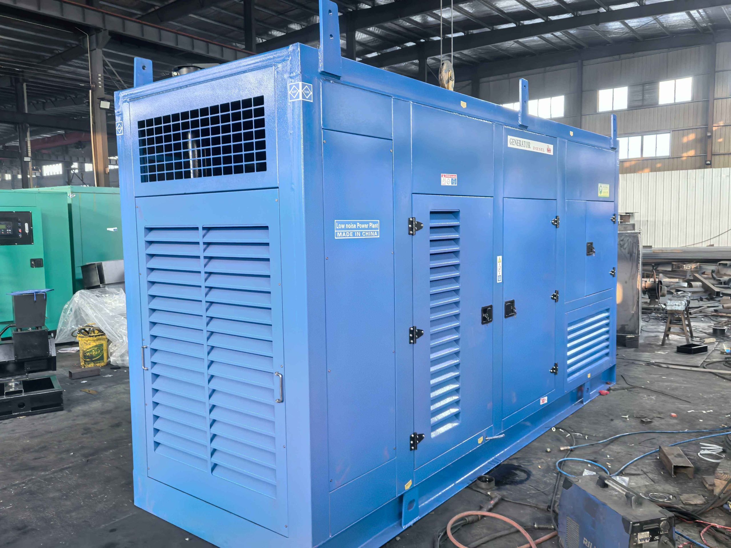 Portable diesel generator set on a wheeled frame with a canopy and lifting eye visible