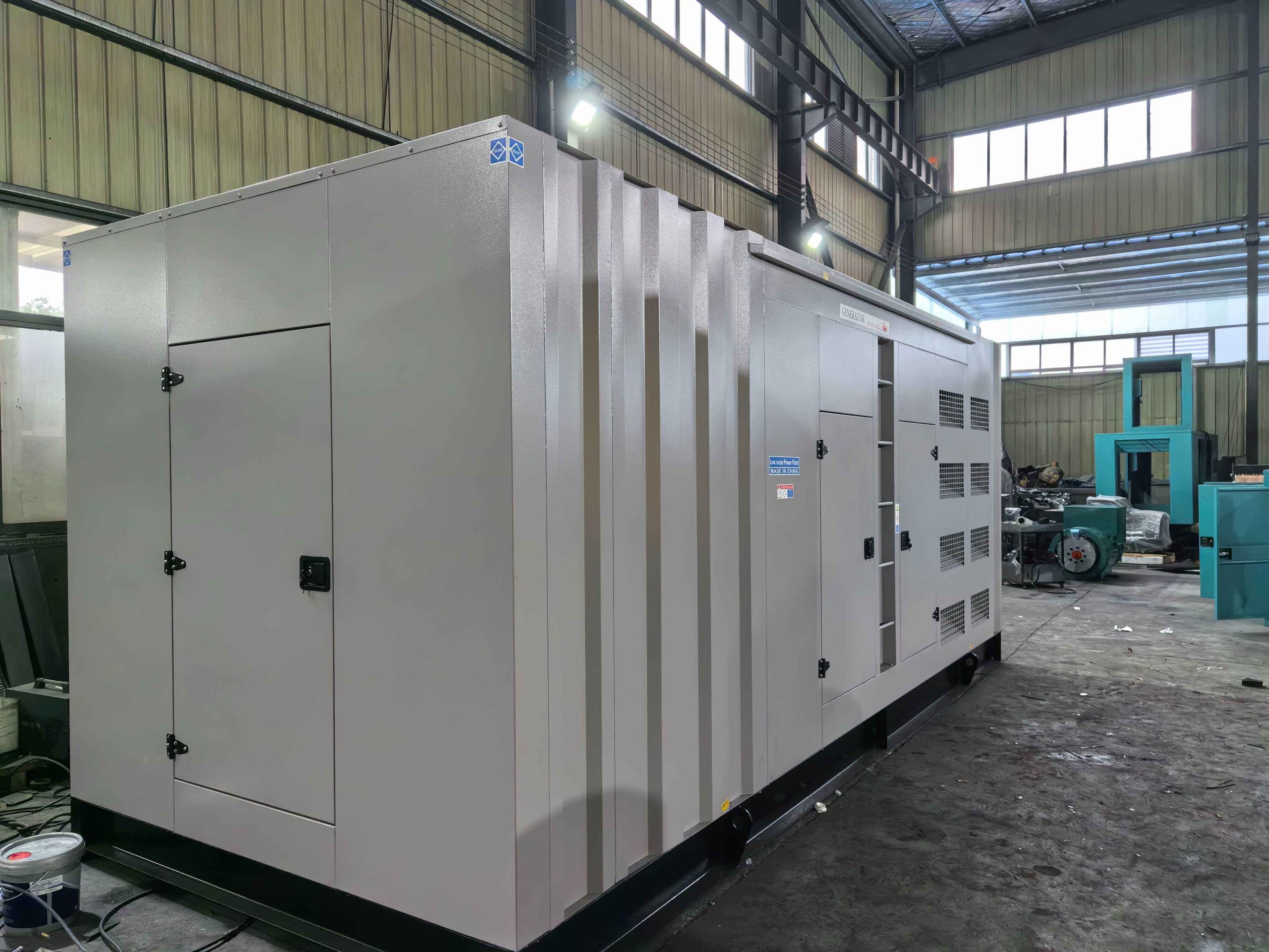 Industrial diesel generator set with exhaust stack and control panel installed in an equipment yard