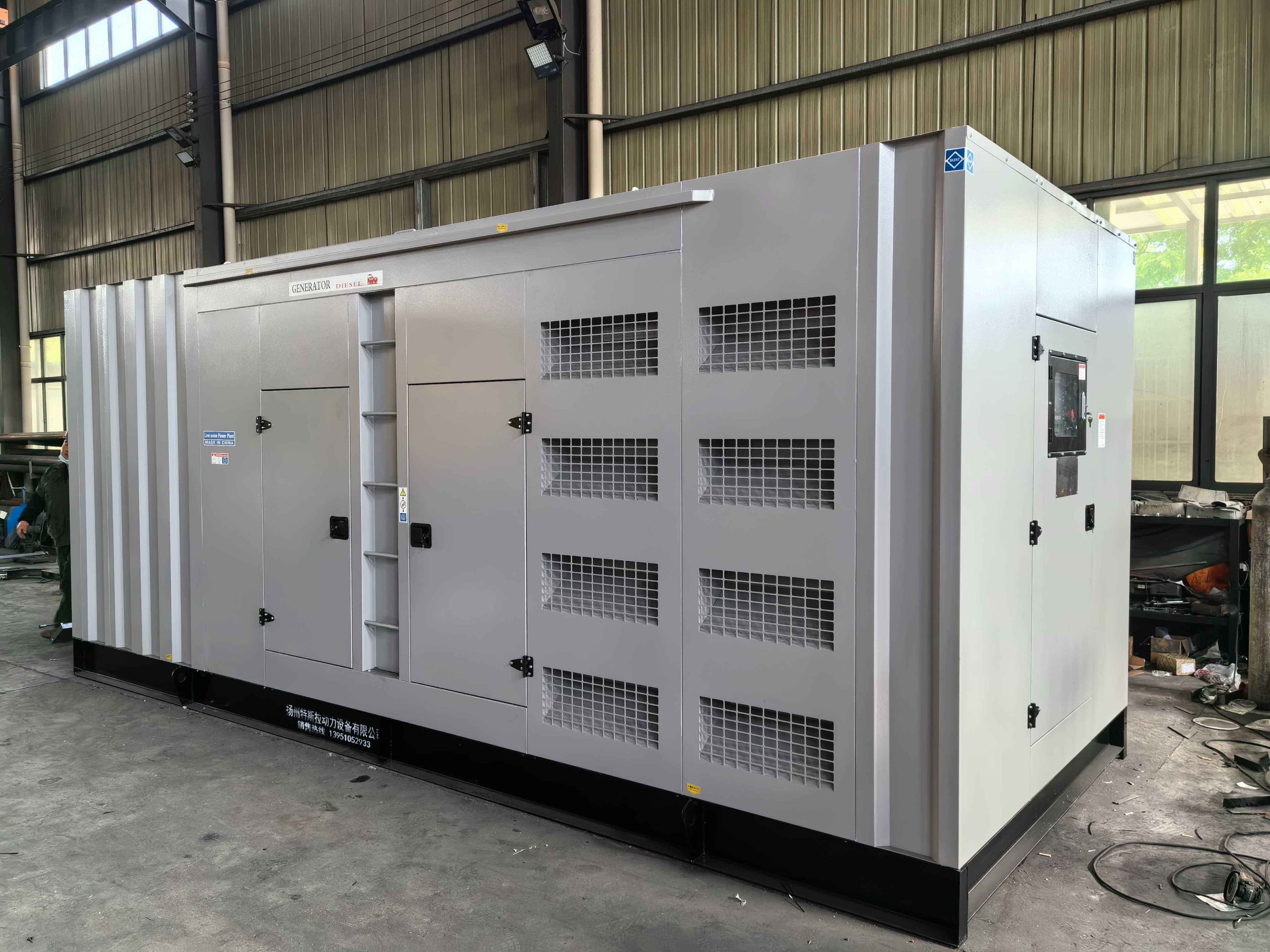 Diesel generator set with control panel open during a commissioning check on site