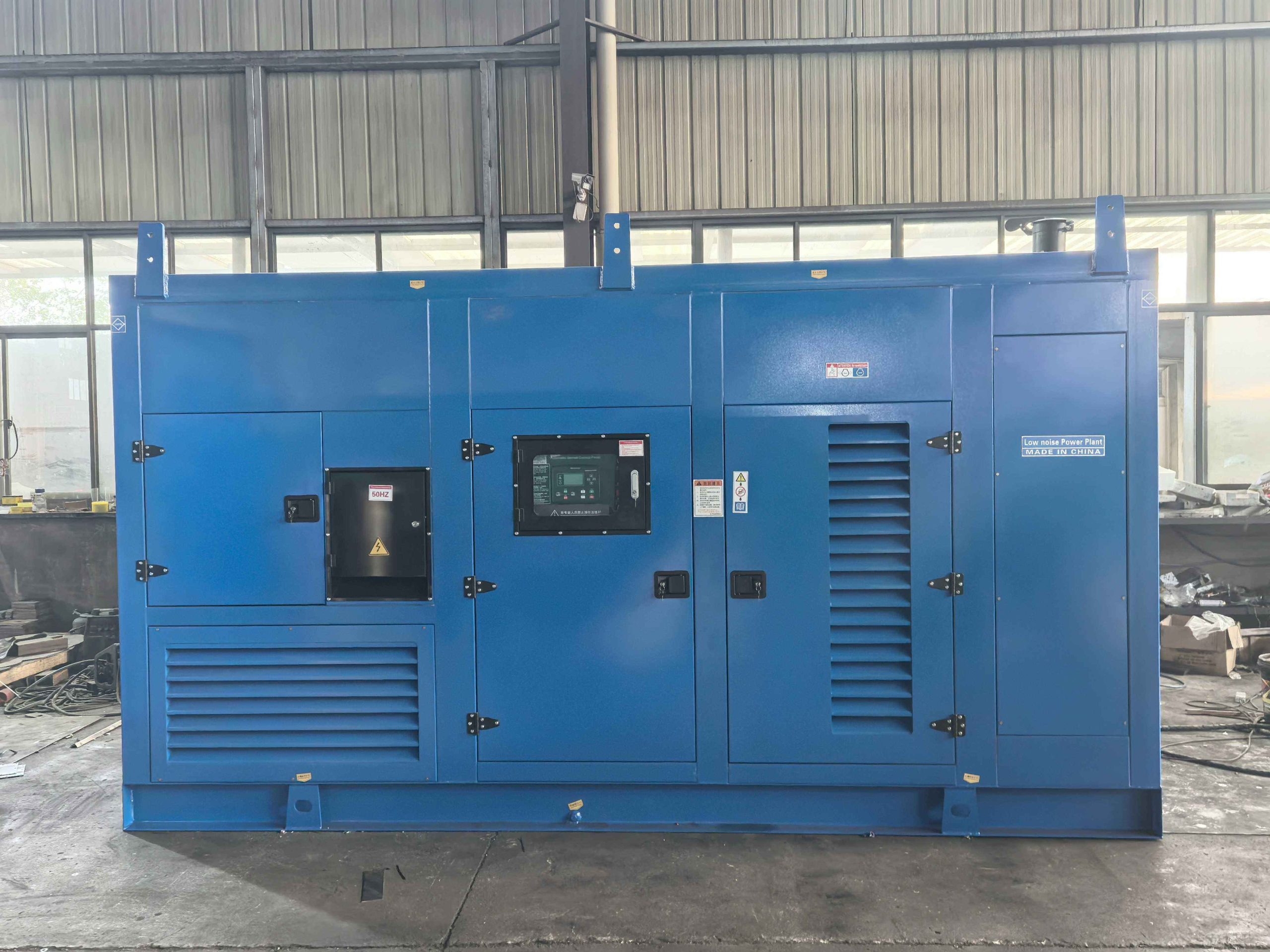 Diesel generator set filters and service points visible inside an open canopy on site